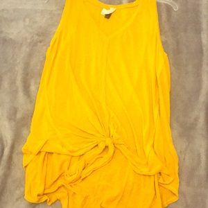 A yellow tee with knot on the bottom